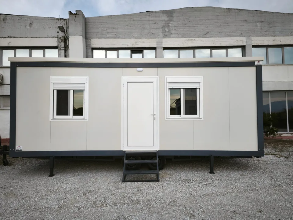 White Classic Line mobile home with a door, two windows and entrance steps