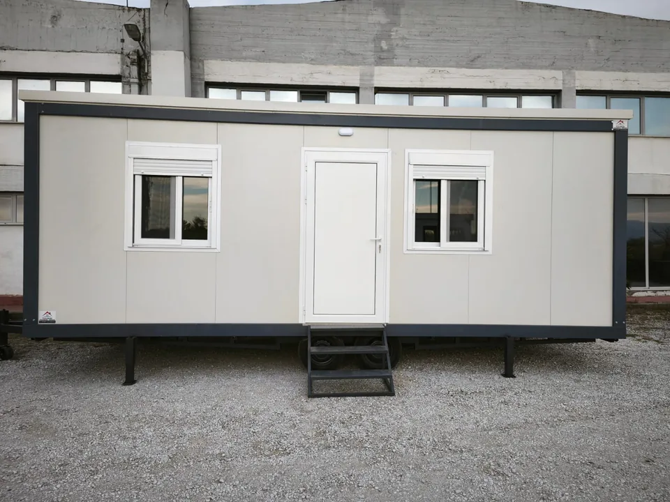 White Classic Line with entrance steps, in a gravel yard