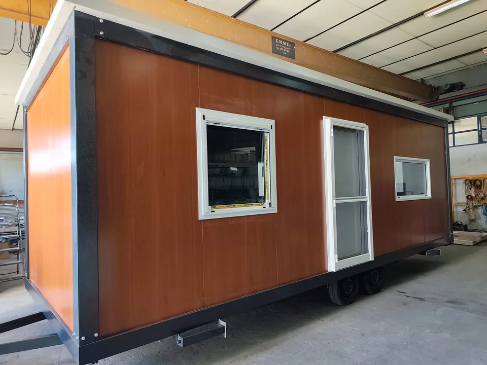 Cabin with dark wood-look panels and a flat roof