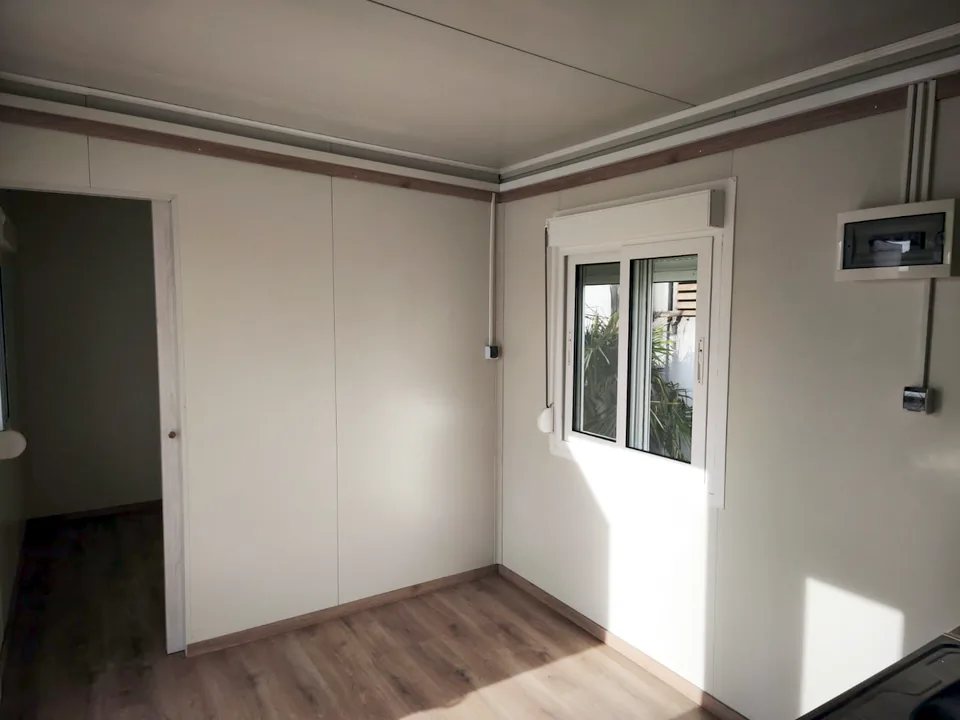 Room with a shuttered window and timber floor