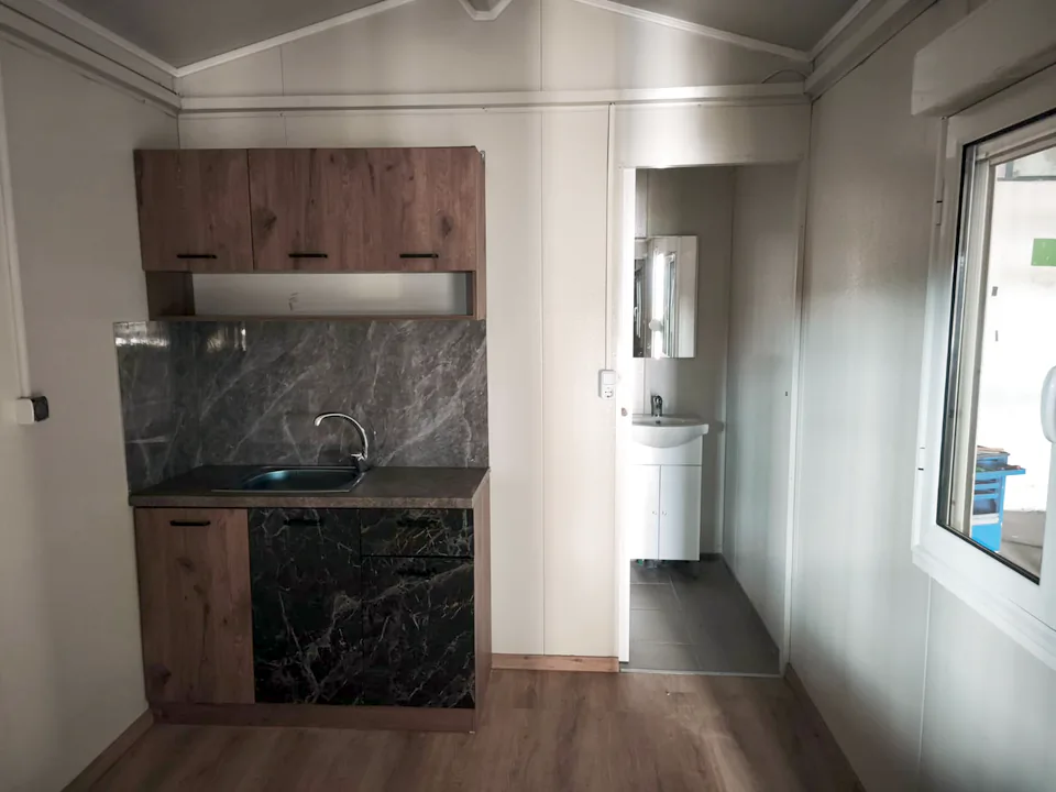 Kitchen and bathroom, lit by a large window
