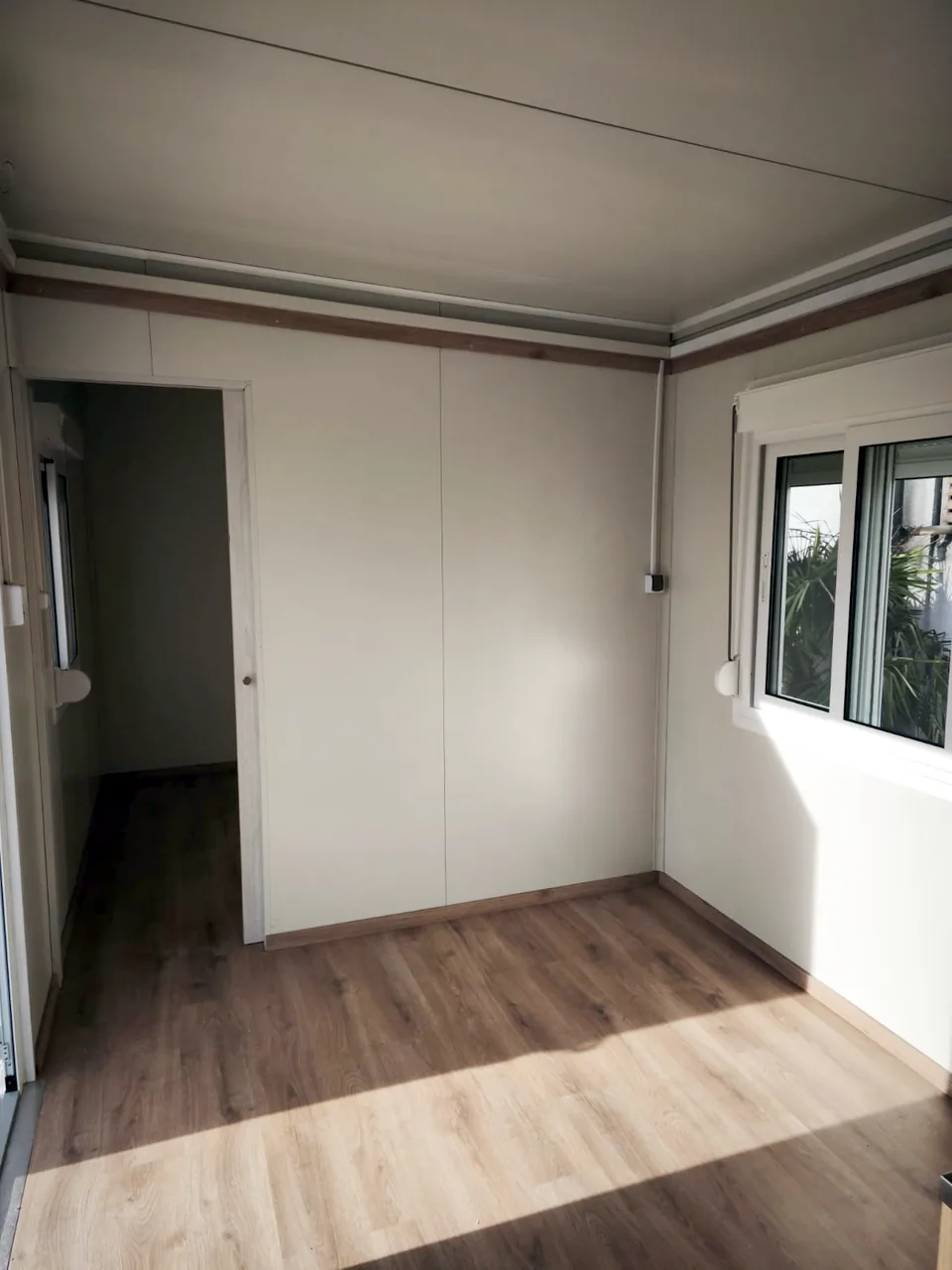Room with a window and a door to the hallway
