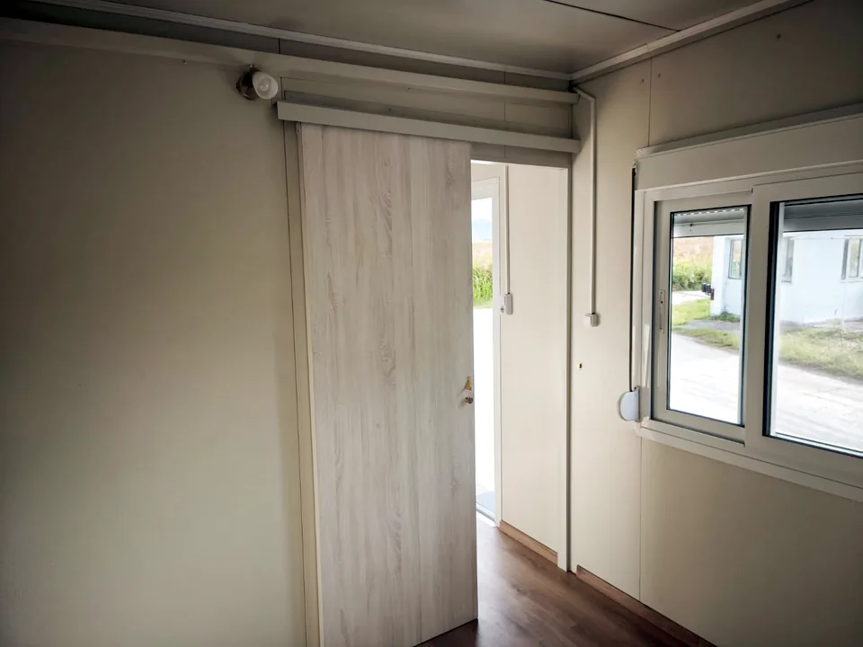 Room with a sliding door and a window